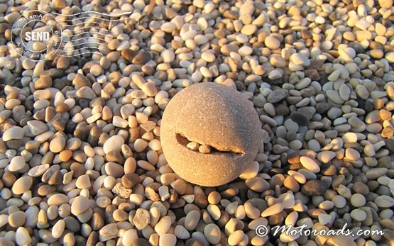 Smiling stone on the beach