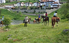 Horseback riding along Dospat Lake